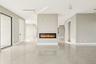 Unfurnished living room featuring a glass covered fireplace and recessed lighting