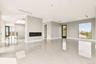 Unfurnished living room featuring light tile patterned floors and a glass covered fireplace