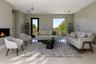 Living room featuring a warm lit fireplace and light tile patterned floors