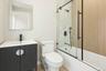 Bathroom with enclosed tub / shower combo and vanity