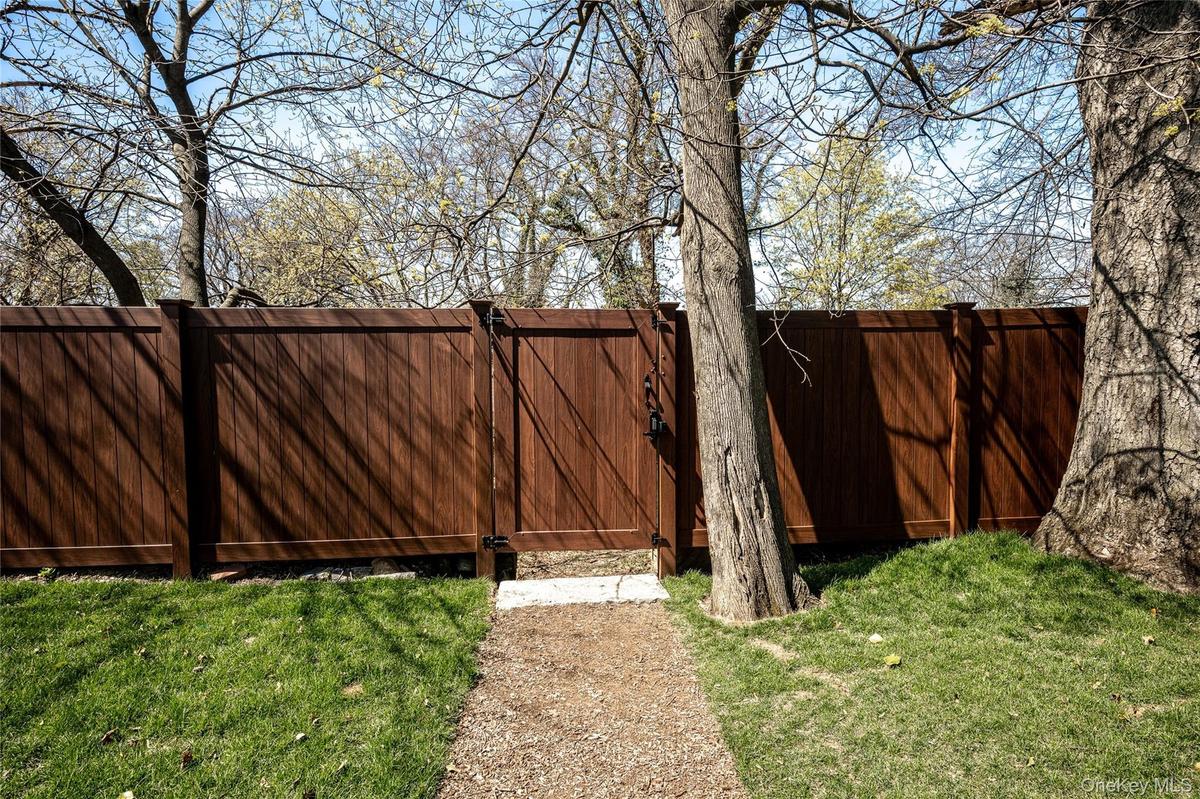 The property features a gate with direct access to the Old Croton Aqueduct Trail, providing a convenient pedestrian connection into the Village of Irv