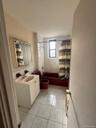 Bathroom featuring vanity, shower / bath combination with curtain, and light tile patterned flooring