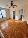 Unfurnished bedroom with ceiling fan, radiator, and crown molding