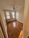 Spare room featuring radiator heating unit and a ceiling fan