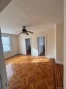 Unfurnished bedroom with a spacious closet and ceiling fan