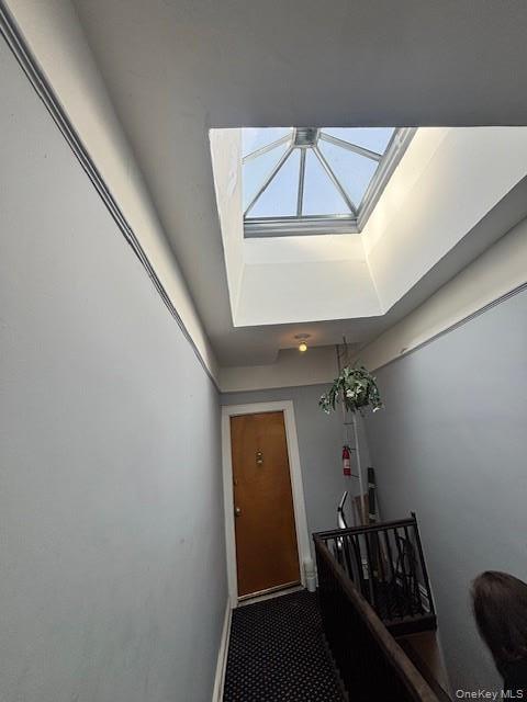 Doorway featuring baseboards and a raised ceiling