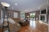 Living room with hardwood floors, recessed lighting, crown molding, a gas fireplace, and French doors to deck overlooking the in-ground pool complex.