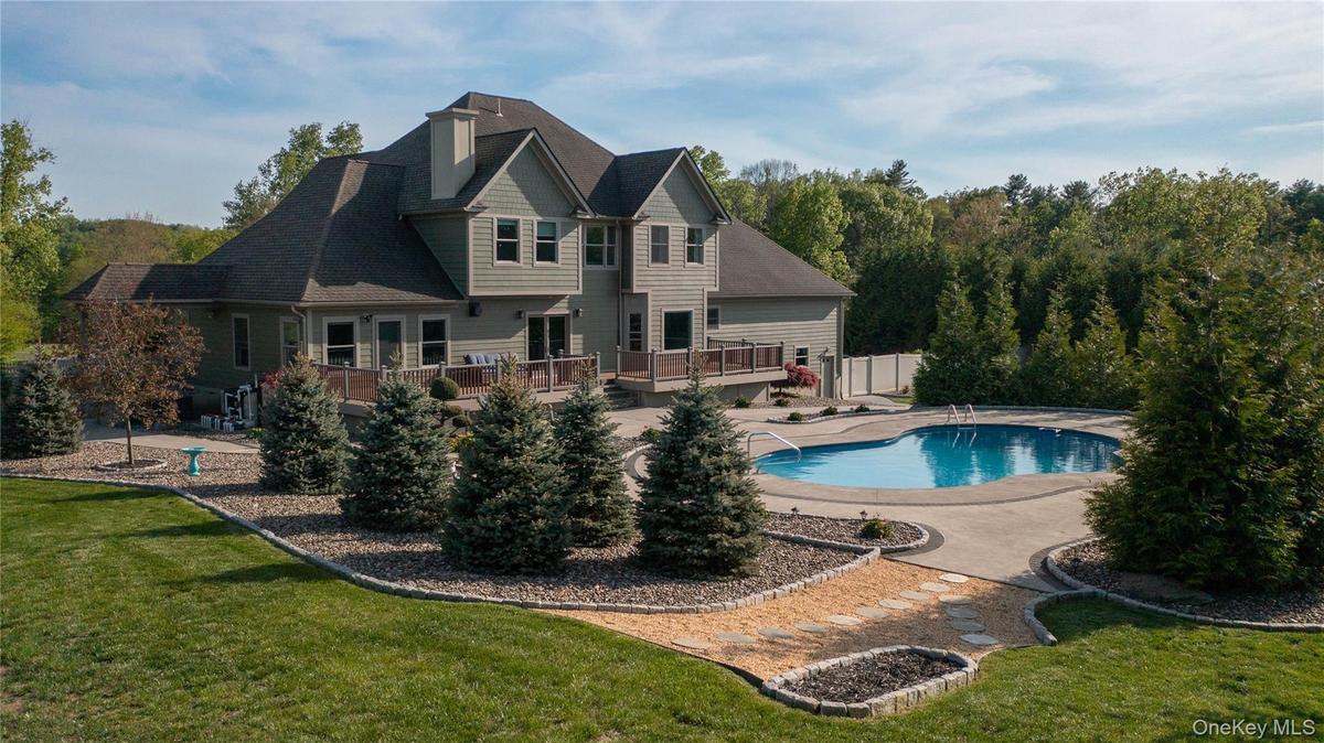 A backyard daydream, where a pristine pool and playful pops of luxury invite you to dive right in.