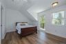 Bedroom featuring access to Juliet balcony, engineered wood flooring, high ceilings and ensuite bath.