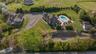 Aerial overview of property's location featuring a stunning pool complex with lush landscape