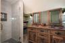 Bathroom with a tile and glass shower and double vanity