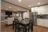 Dining space featuring wood-style flooring, recessed lighting, and is open to a lounge area.