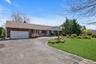 Two-car garage, and a paved driveway with brick edging