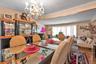 Dining area featuring a mirrored table, chandelier lighting, wood-finish flooring, built-in display cabinetry