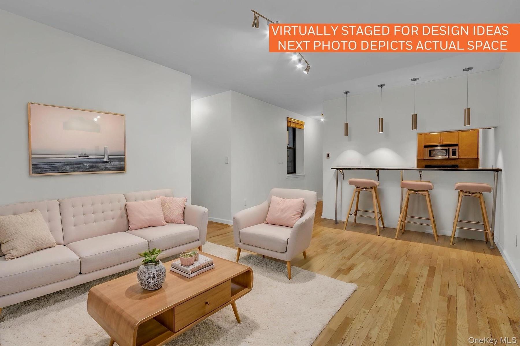 Open concept living area featuring wood-finish flooring and a breakfast bar