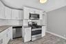 Unit #2-Kitchen featuring granite countertops and stainless-steel appliances.