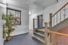 Staircase featuring decorative metal balusters and wood handrails