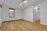 Expansive room featuring natural wood-finish flooring