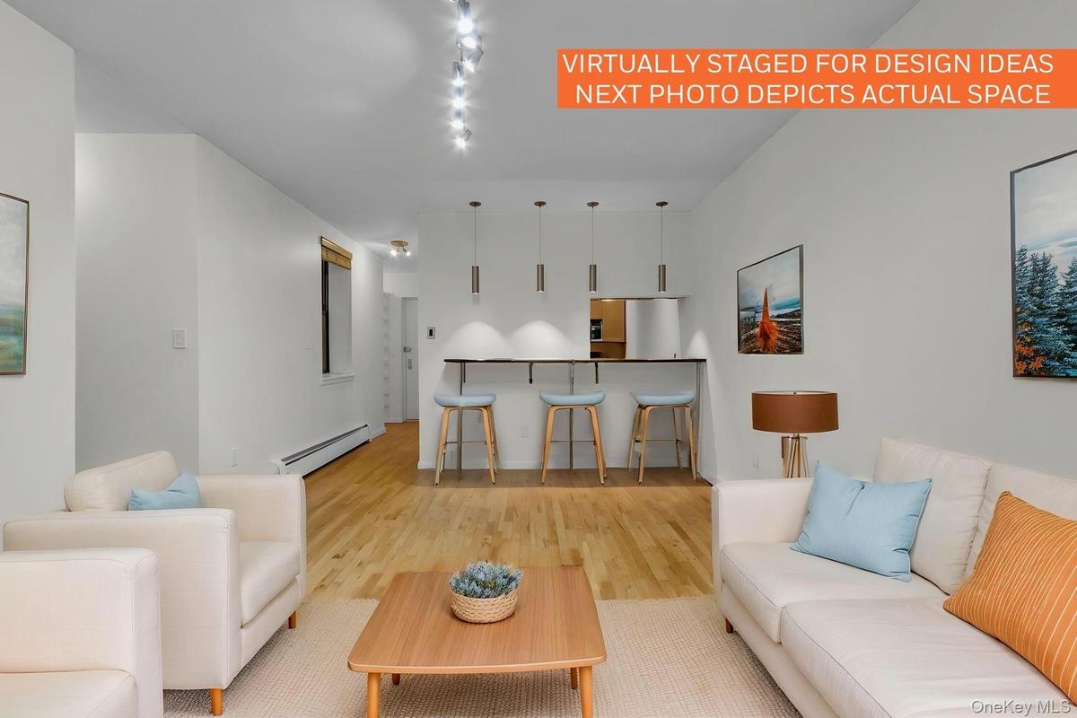 Open-concept living area with wood-finish flooring