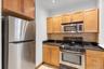 Kitchen featuring stainless steel appliances including a refrigerator, microwave, and range