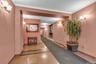 Entryway featuring two-tone walls, crown molding, and sconce lighting
