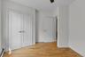 Light wood-finish flooring provides a warm base for the crisp white walls and trim