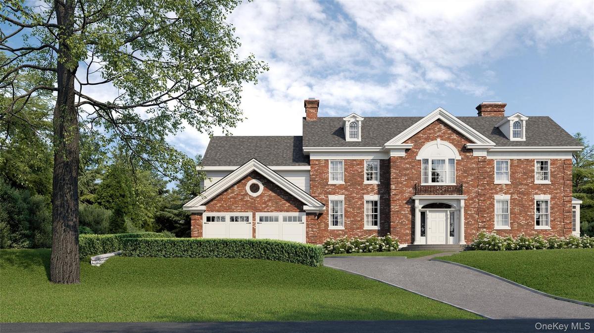 Colonial-style house with driveway, a chimney, and a front lawn