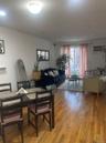 Open-concept living area with wood-finish flooring, recessed lighting, and a prominent sliding glass door