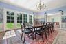 Dining space with a chandelier, ornamental molding, and light wood-type flooring