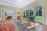 Sunroom / solarium featuring plenty of natural light and a chandelier