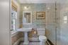 Bathroom featuring an enclosed shower, toilet, and a wealth of natural light
