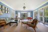 Living area featuring plenty of natural light, ornamental molding, and carpet floors