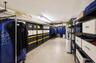 Utility room featuring extensive metal shelving units and durable concrete flooring