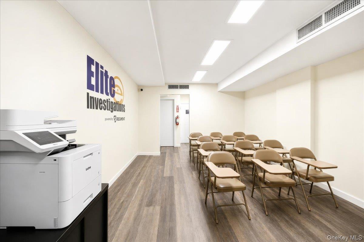 Commercial space featuring wood-finish flooring, recessed lighting, and white walls