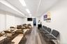 Spacious room featuring wood-finish flooring, recessed lighting, and a wall-mounted flat-screen display