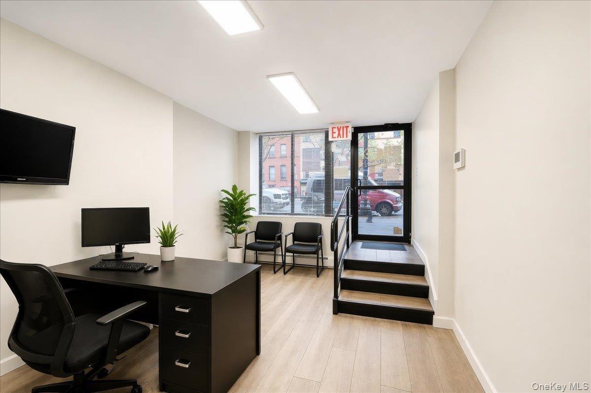 Interior space featuring light wood-finish flooring, white walls, and recessed lighting