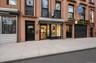 Street-level storefronts with large display windows and direct street access