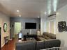 Living area featuring wood-finish flooring, recessed lighting, and an arched doorway