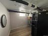 Recessed lighting illuminates wood-finish flooring