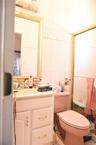 Half bath with tile walls and vanity