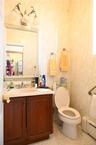 Half bath featuring vanity, a baseboard radiator, and light tile patterned floors