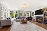 Fully windowed and wood burning fireplace in a room of grandeur in size