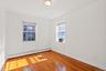 Empty room featuring a baseboard radiator and light hardwood / wood-style flooring