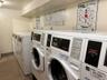 Shared laundry featuring washer and dryer and baseboards