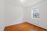 Empty room featuring a baseboard radiator and wood-type flooring