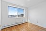 Unfurnished room featuring a baseboard radiator and light hardwood / wood-style floors