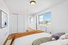 Virtual Staged Bedroom featuring wood finished floors, baseboards, and a closet