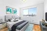 Virtual Staged Bedroom with baseboard heating and light wood-type flooring