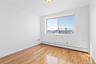 Empty room featuring light wood-type flooring and baseboard heating