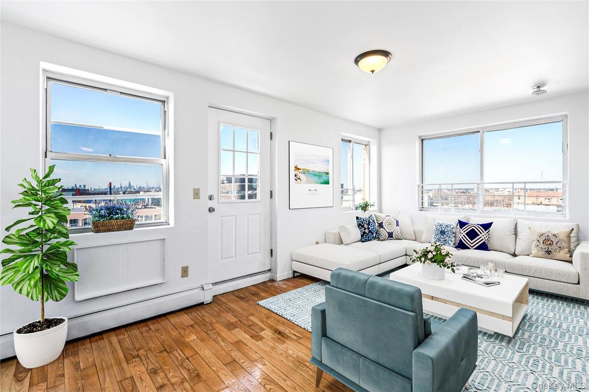 Virtual Staged Living area with healthy amount of natural light and hardwood / wood-style flooring